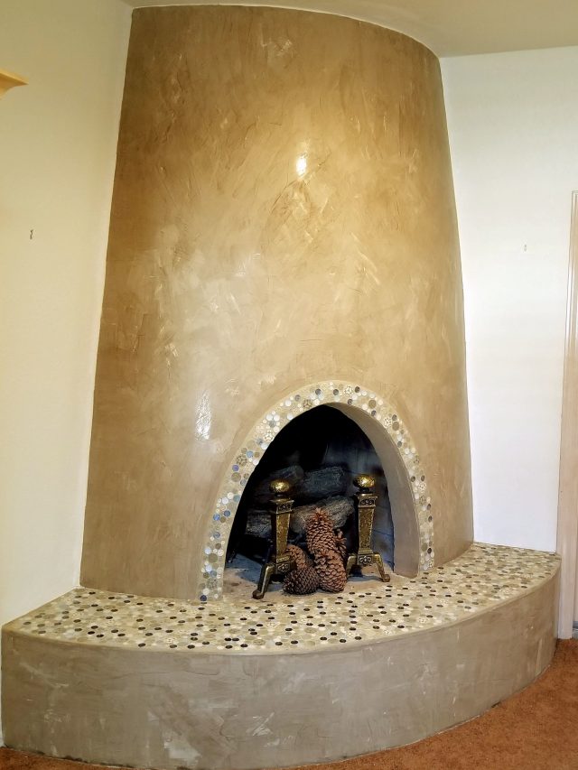 concrete fireplace remodel with button mosaic