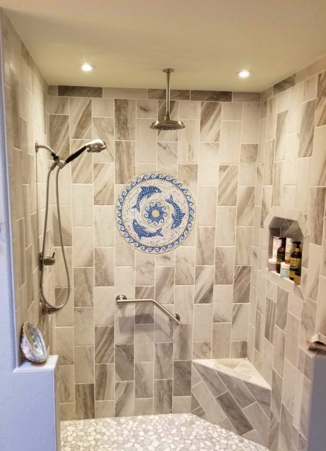shower remodel with dolphins tile mosaic on wall
