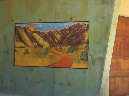 stained scenery mural on concrete driveway wall